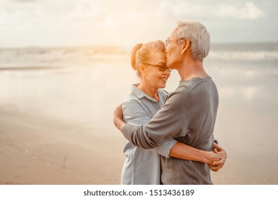 Senior lovers hug and kiss each other in the sunset on the beach Plan life insurance with a happy retirement concept. - Powered by Shutterstock