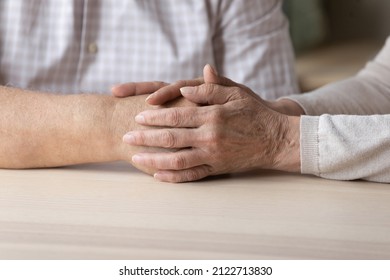 Senior loving wife holding hand of older husband, giving support, love, compassion, comfort. Mature couple going through stress, problems together. Hand touch close up. Marriage, relationships concept - Shutterstock ID 2122713830