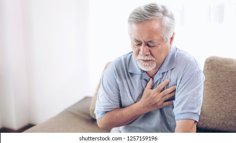 Senior Male Asian Suffering From Bad Pain In His Chest Heart Attack At Home - Senior Heart Disease