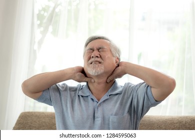 Senior male asian  suffering from bad pain in Neck pain at home - senior unhealth 