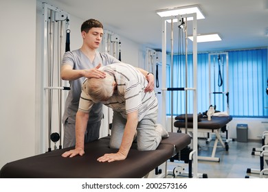 Senior Male In Crawling Position Bending His Back