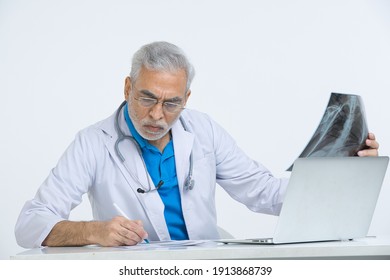 
Senior male doctor analyzing x-ray image in hospital.