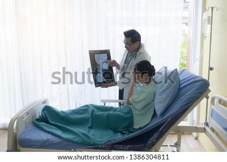 Similar – Female doctor showing an x-ray on the tablet