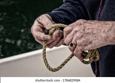 Senior Male Hands Tying Rope on a Boat