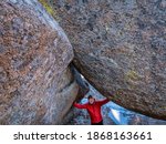 senior male hiker and granite rock formation in Vedauwoo Recreation Area, Wyoming,  known to the Arapaho Indians as Land of the Earthborn Spirit, winter scenery