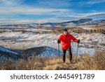 senior male hiker reaching top of a hill at foothills of Rocky Mountains - winter scenery at Devil