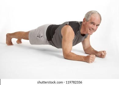 Senior male holds yoga pose