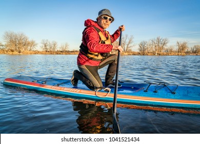 Senior Male Paddler On A Racing Stand Up Paddle Board, A Lake In Colorado In Winter Or Early Spring Scenery