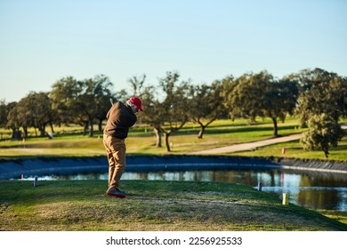 senior male playing golf ready to hit the ball - Shutterstock ID 2256925533