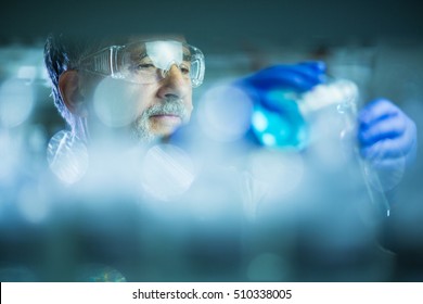 Senior male researcher carrying out scientific research in a lab (shallow DOF; color toned image) - Powered by Shutterstock