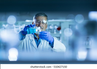 Senior Male Researcher Carrying Out Scientific Research In A Lab (shallow DOF; Color Toned Image)