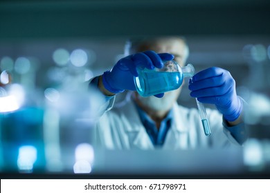 Senior male researcher carrying out scientific research in a lab (shallow DOF; color toned image) - Powered by Shutterstock