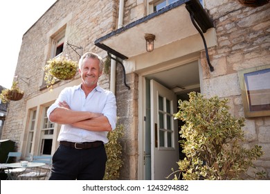 Senior Male Restaurant Pub Owner Stands Outside The Entrance