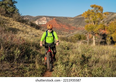 A Senior Male Riding A Fat Mountain Bike On A Single Track Trail In Red Mountain Open Space In Colorado, Fall Scenery