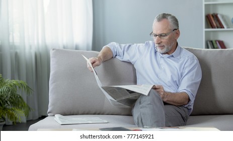 Senior Male Sitting On Sofa And Reading Newspaper, Press And News, Rest Time