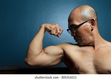 Senior Man In 60 Years Old Showing Biceps.