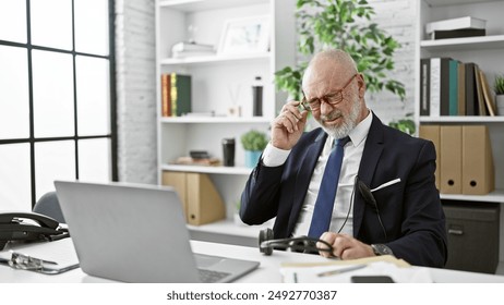 A senior man adjusts his glasses during work in a modern office, portraying exhaustion and focus. - Powered by Shutterstock