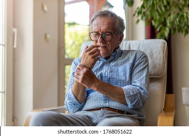 Senior Man With Arthritis Rubbing Hands
