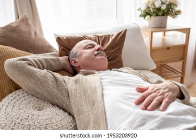 Senior Man Asleep In Bed At Home Napping After Breakfast