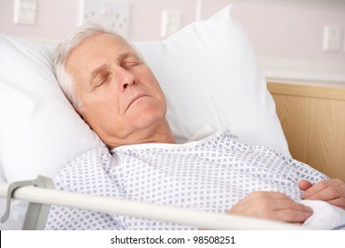 Senior Man Asleep In Hospital Bed