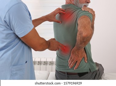 Senior Man With Back Pain. Spine Physical Therapist And Paient. Chiropractic Pain Relief Therapy.