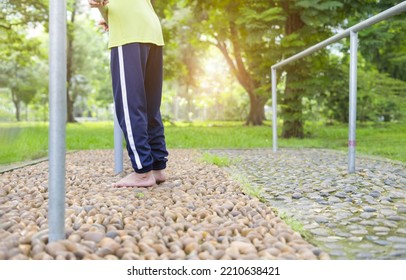 Senior Man With Bare Feet Try To Walking By Himself On Concrete Stone Floor, Older Adult Physical Rehab At The Park.concept Self Health Therapy On Old People Or Patient 