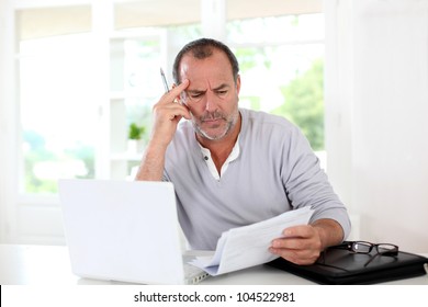 Senior Man Being Puzzled With Tax Documents