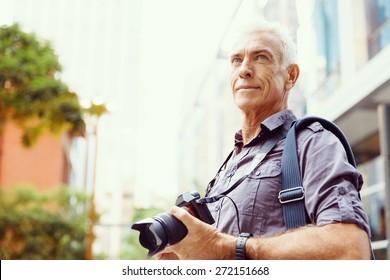 Senior Man With Camera In City