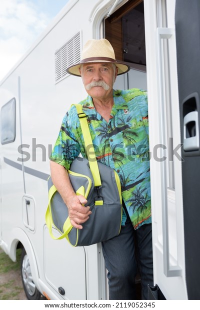 senior man in camper\
van