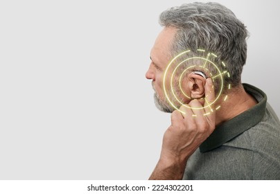 Senior Man Can Hear Sounds With Hearing Aid Behind The Ear With Virtual Sound Waves. Hearing Loss Treatment Concept At Older People