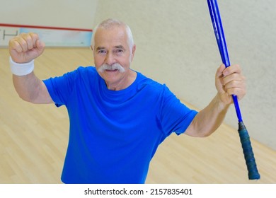 senior man celebrating a win on the squash court - Shutterstock ID 2157835401
