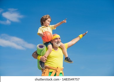 Senior Man And Child In Family Health Club. Doing Sports Is Free. Grandpa And Grandson Spotting. Grandfather And Child Is Doing Sport Outdoors