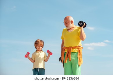 Senior Man And Child In Family Health Club. Healthy Lifestyle. Grandfather And Grandson With Dumbbells In Hands. Sport For Little Children