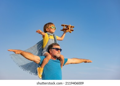 Senior Man And Child Playing Outdoor Against Summer Sky Background. Grandfather And Boy Having Fun Together. Family Holiday Concept. Happy Fathers Day