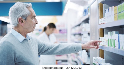 Senior man, choice or shopping in pharmacy for medicine, wellness or thinking for supplement option. Elderly customer, vitamins or pointing at chemist shelf for pharmaceutical, boxes or reading label - Powered by Shutterstock