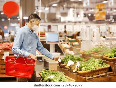 Senior Man Choosing  groceries, vegetables, fruits in the supermarket.face mask  - Powered by Shutterstock