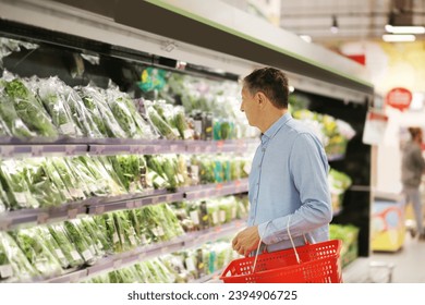 Senior Man Choosing  groceries, vegetables, fruits in the supermarket - Powered by Shutterstock