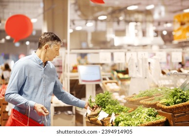 Senior Man Choosing  groceries, vegetables, fruits in the supermarket - Powered by Shutterstock