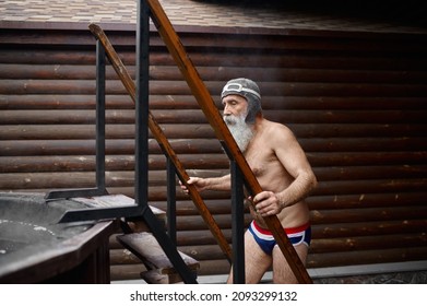 Senior Man Climbing Stairs To Outside Bathtub