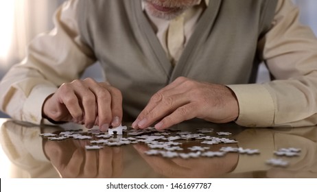 Senior Man Collecting Puzzle, Alzheimer Disease Awareness Concentration Exercise