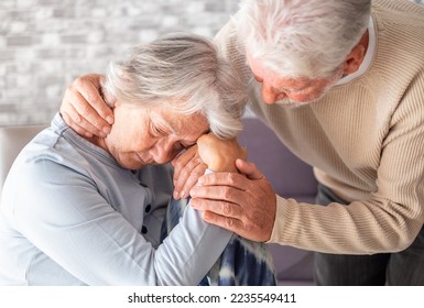 Senior man comforting his depressed illness wife, unhappy elderly woman at home. Ourmindsmatter