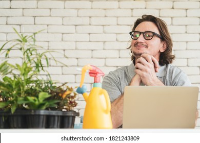 Senior man with computer doing small tree online business at home, Retirement lifestyle concept