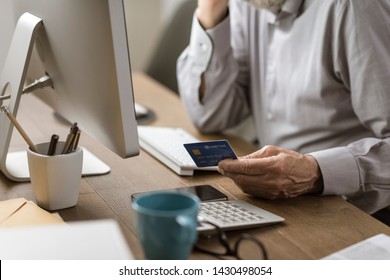 Senior Man Connecting With His Computer And Doing Online Shopping Using A Credit Card, Elderly And Technology Concept