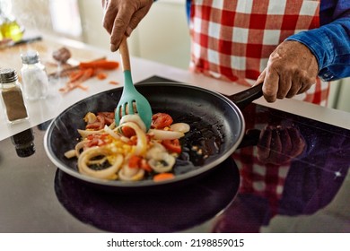 Senior Man Cooking At Kitchen