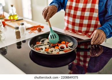 Senior Man Cooking At Kitchen