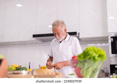 Senior Man Cooking Meal At Home In The Morning,Elderly Healthy Food Concept,Preparing Breakfast