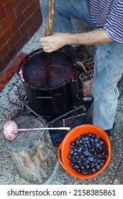 Senior Man Cooking Plum Marmalade Jam