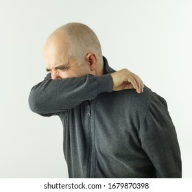 senior man coughing in an elbow on white background - Powered by Shutterstock