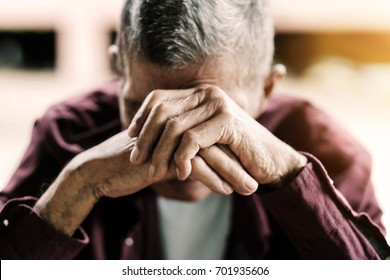 senior man covering his face with his hands.vintage tone - Powered by Shutterstock