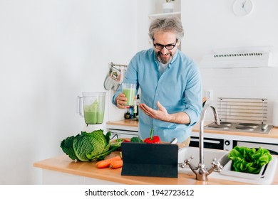 Senior man creating content for culinary blog, explaining the recipe step by step. Senior man using tablet for blogging - Powered by Shutterstock